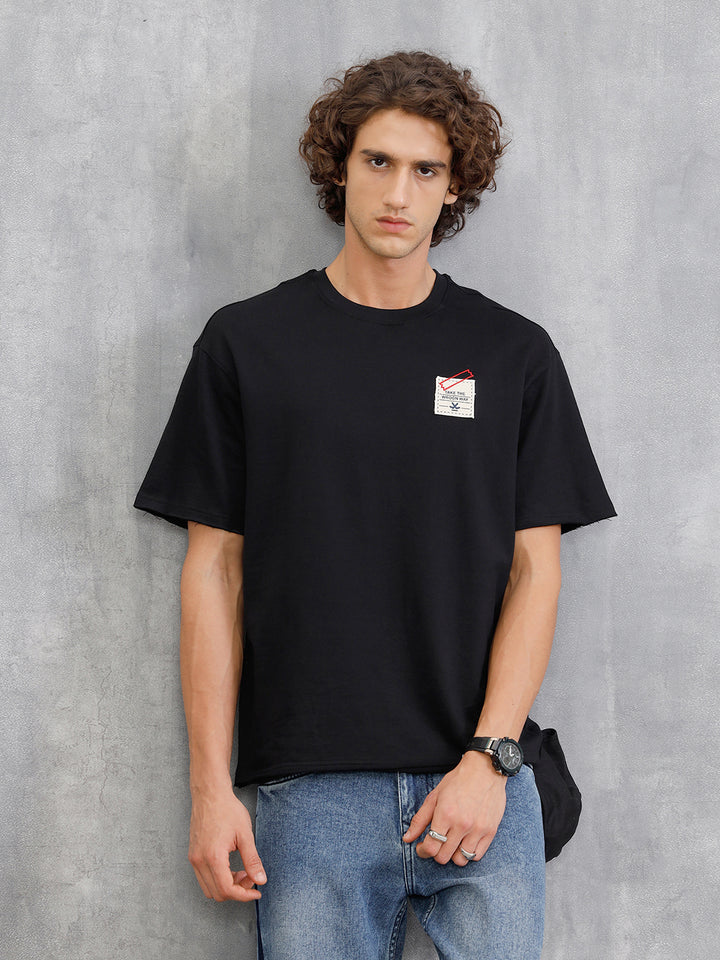 Solid Oversized T-Shirt With Printed Canvas Patch And Raw Edge Detail | Black