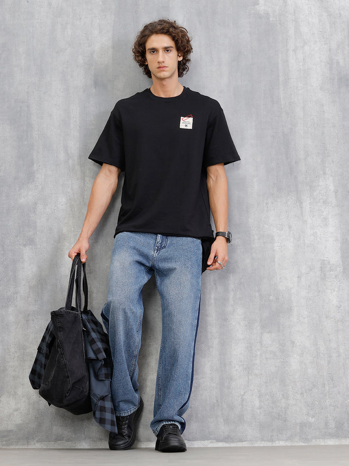 Solid Oversized T-Shirt With Printed Canvas Patch And Raw Edge Detail | Black